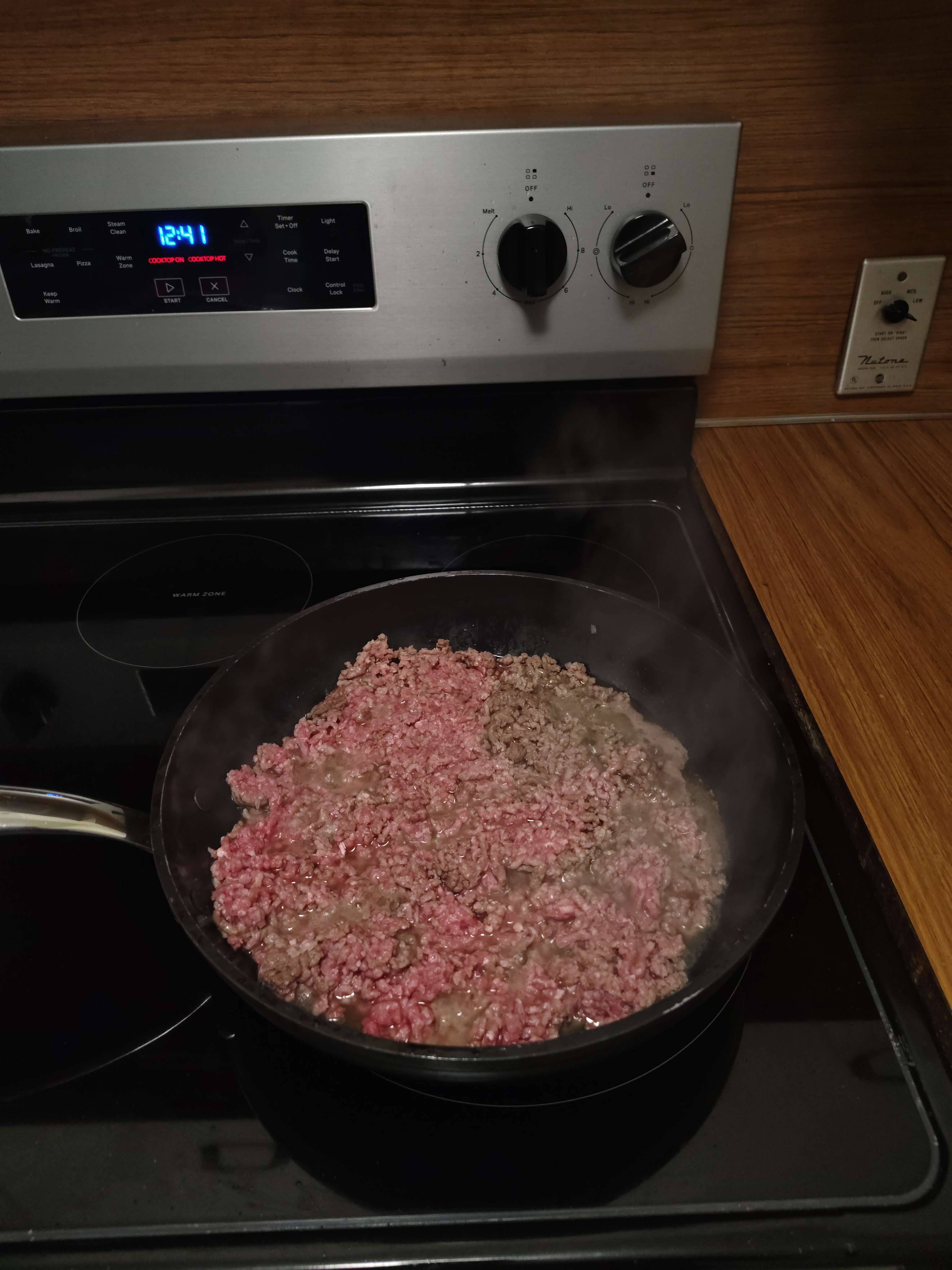 photo of partially meat in pan